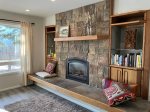 Stone gas fireplace with mountain views